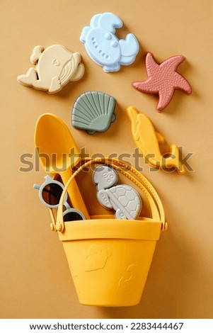 Silicone bucket with children's toys for the beach. Flat lay, top view. Royalty-Free Stock Photo #2283444467