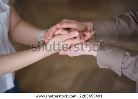 two women holding hands, emphasizing the importance of self-care and emotional well-being. The concept highlights the benefits of relaxation aids and therapeutic activities such as yoga, meditatio Royalty-Free Stock Photo #2283455481