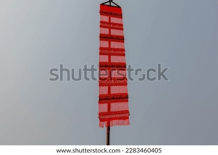 Handmade traditional red pink Lanna Tung hanging on the bamboo pole in Thai Temple, Tung is a symbol of the northern style object, Used to decorate or perform rituals according to beliefs, Thailand. Royalty-Free Stock Photo #2283460405