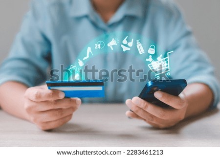 Woman using smart phone and credit card paying for online shopping with virtual graphic icons. Mobile payment with wallet app technology. Digital banking, e-commerce and financial technology concept