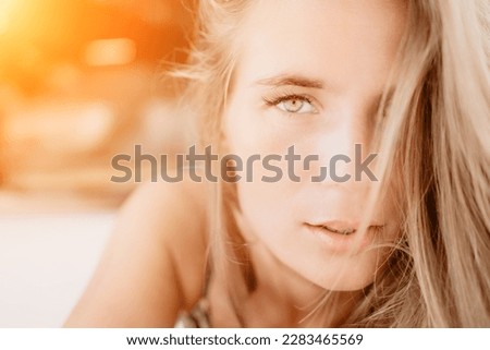 Happy woman portrait in cafe. Boho chic fashion style. Outdoor photo of young happy woman with long hair, sunny weather outdoors sitting in modern cafe.