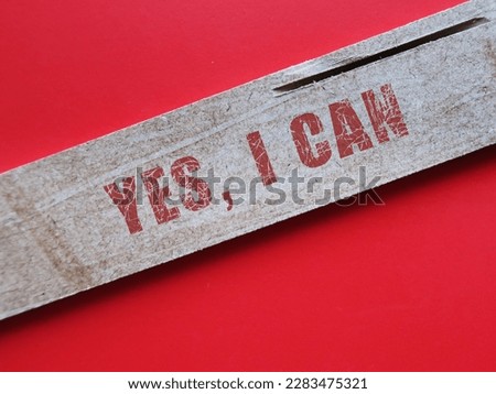 Wood on red background with text YES I CAN, concept of self talk or affirmation to boost power of positive thoughts, increase self-esteem and build growth mindset