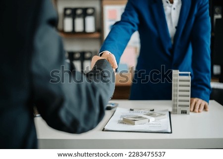 Sales giving male customer signing sales contract, Asian woman and man doing business in modern office, business concept and contract signing.