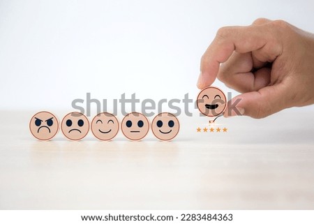 Smiley face on wooden toy for customer services rating feedback satisfaction survey business review questionnaire development for service mind, social media digital global marketing management