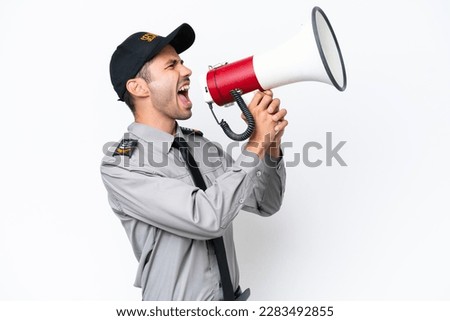 Young safeguard man over isolated white background shouting through a megaphone