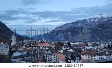 A city in Switzerland named Chur with a view on mountains in background.