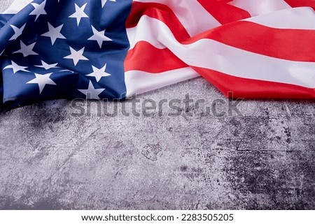 USA Memorial day, Presidents day, Veterans day, Labor day, or 4th of July celebration. Closeup of American flag on dark cement background