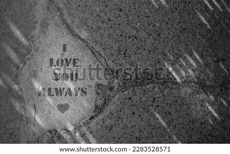 I love you always P. Confession of love written on the concrete sidewalk. Words of love. Black and white abstract photo. 