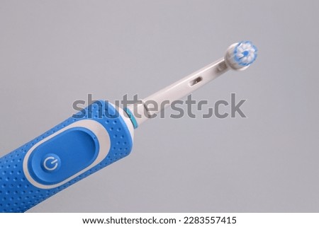 Electric toothbrush on a gray background