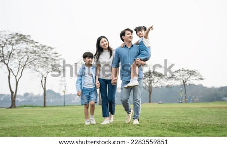 Asian family photo walking together in the park Royalty-Free Stock Photo #2283559851