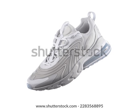 White sneaker with light blue accents on a white isolated background, sport concept, men's fashion, sport shoe, air, sneakers, lifestyle, concept, product photo, levitation concept, street  Royalty-Free Stock Photo #2283568895