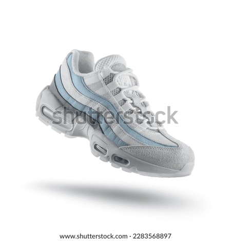 White sneaker with light blue accents on a white isolated background, sport concept, men's fashion, sport shoe, air, sneakers, lifestyle, concept, product photo, levitation concept, street  Royalty-Free Stock Photo #2283568897