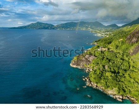 Aerial view of the coastline of Mahe Island in the Seychelles. Rocky coast and tropical forest. Tropical landscape in the Indian Ocean