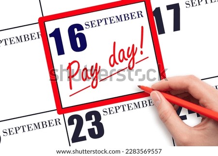 16th day of September. Hand writing text PAY DATE on calendar date September  16 and underline it. Payment due date.  Reminder concept of payment. Autumn month, day of the year concept.