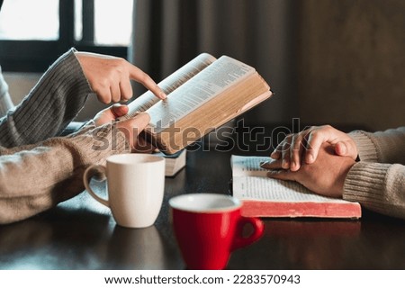 Small group of asian people praying worship believe. Teams of friends worship together before studying Holy bible. family praying together in church. Small group learning with prayer concept. Royalty-Free Stock Photo #2283570943