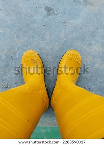 Orange safety boots and made of rubber.