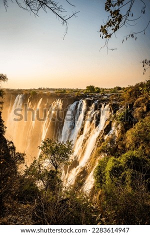 Sunset at the Victoria Falls, also known as Mosi-oa-Tunya, in Zambia, closeby the border to Zimbabwe Royalty-Free Stock Photo #2283614947