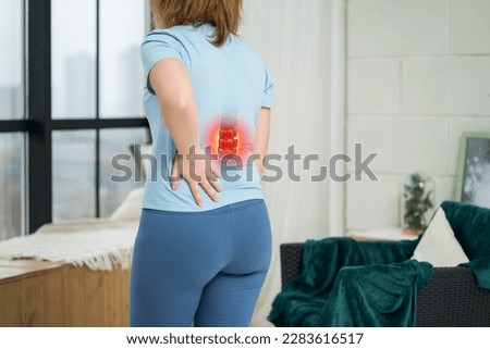 Lumbar intervertebral spine hernia, woman with back pain at home, spinal disc disease, health problems concept Royalty-Free Stock Photo #2283616517