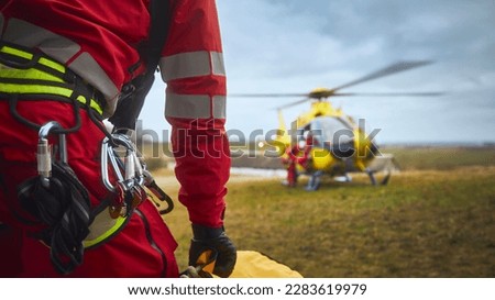 Selective focus on safety harness of paramedic of emergency service in front of helicopter. Themes rescue, help and hope.
 Royalty-Free Stock Photo #2283619979