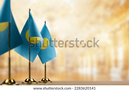 A small Palau flag on an abstract blurry background. Royalty-Free Stock Photo #2283620141