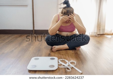 Obese Woman with fat upset about her belly. Overweight woman touching his fat belly and want to lose weight. Fat woman worried about weight diet lifestyle Royalty-Free Stock Photo #2283624237