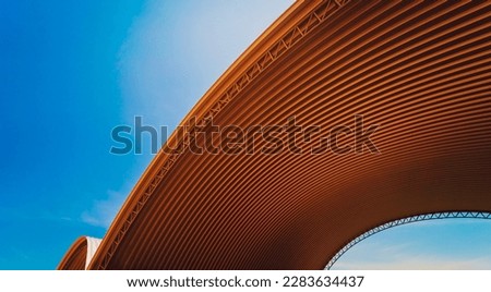 Abstract background spiral metal arch on blue sky