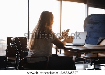 portrait of a young business woman freelancer working at a computer in the office