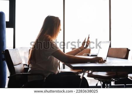 freelancer in an IT company works in a coworking space behind a laptop