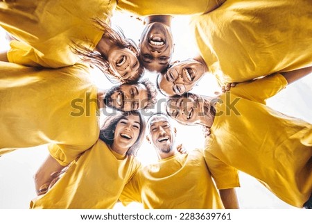 Multiethnic young people hugging outside - Youth community concept with guys and girls supporting each other - Multiracial volunteers standing in circle together  Royalty-Free Stock Photo #2283639761
