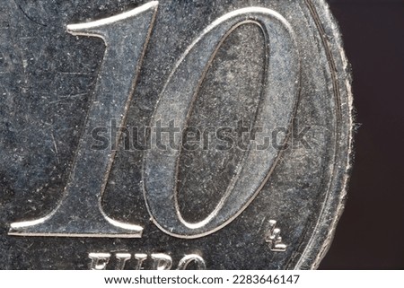 Partial extreme close up of a ten euro cent cents brass coin as concept for cash and euro coins Royalty-Free Stock Photo #2283646147