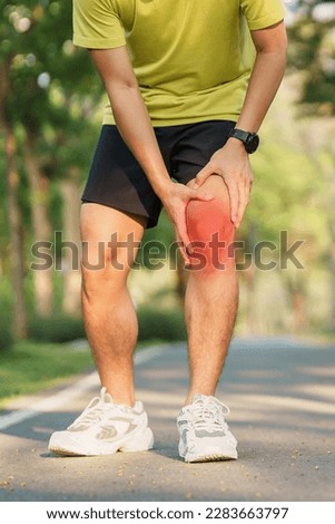 Young adult male with muscle pain during running. runner have knee ache due to Runners Knee or Patellofemoral Pain Syndrome, osteoarthritis and Patellar Tendinitis. Sports injuries and medical concept Royalty-Free Stock Photo #2283663797