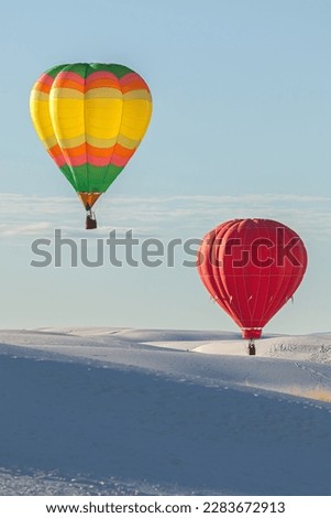 Hot air balloons and white sand dune