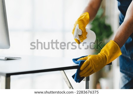 people doing cleaning are using cloths and spraying disinfectant Wipe the glass in the office room.cleaning staff, cleaning maid Royalty-Free Stock Photo #2283676375