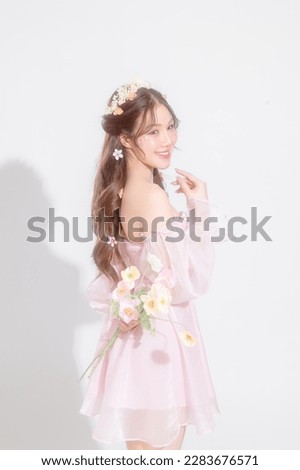 Soft focus. Lovely Asian woman have perfect clear fresh skin with flower make up on her face over isolated white background. Cosmetology, beauty and spa, wellness, Plastic surgery.
