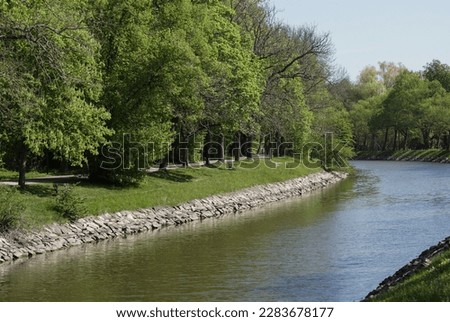 Scenic view of canal in park against clear sky