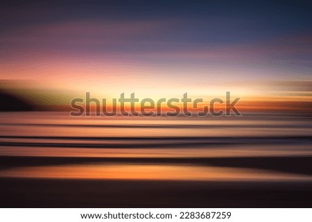 Abstract blurred seascape of colorful sunset over the ocean.