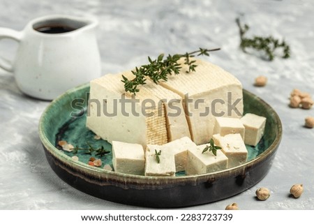 soy cheese tofu diced on a light background, Healthy vegan meatless meal rich in protein and calcium. Food recipe background. Close up,