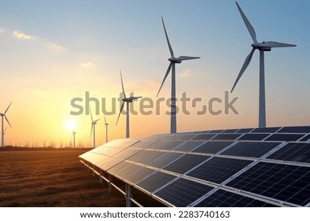 solar power plant with wind turbines at sunset under a blue sky  Royalty-Free Stock Photo #2283740163