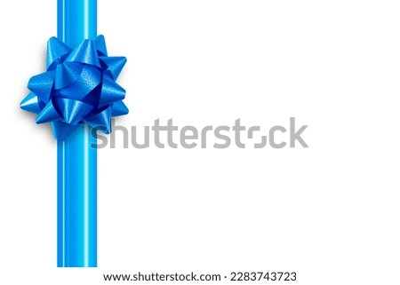 Blue ribbon with a bow for a gift on an isolated white background. Top view, flat lay.