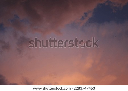 Beautiful pink sunset sky with dramatic heavy clouds 