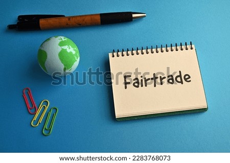 There is a notebook with the word Fair Trade. It is eye-catching image.