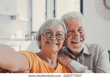 Head shot portrait happy senior couple taking selfie, having fun with phone cam, smiling aged wife and husband hugging, looking at camera, posing for photo, aged man vlogger recording video