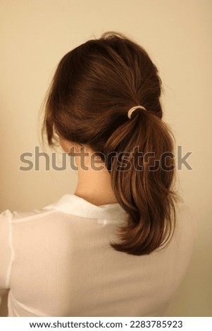 Young woman with thick, wavy dark blonde hair in a ponytail. Low ponytail. Casual hairstyle. Ponytail hairstyle.  Royalty-Free Stock Photo #2283785923