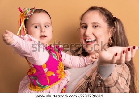 cheerful baby girl and mom to Brazilian Festa Junina in beige colors. calling and inviting