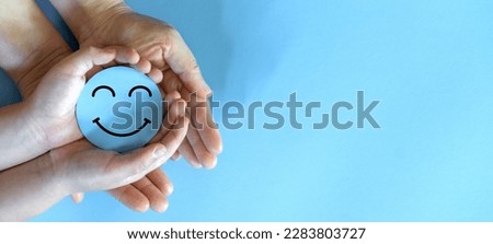 Hand holding paper cut circle symbol face smile, happy, relax,  satisfaction survey, customer services, positive, good, wellness, health child, hospital, world mental health day concept Royalty-Free Stock Photo #2283803727