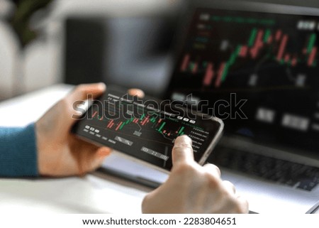 Successful of trader use phone and laptop trading stock exchange graph money of block chain stock market cryptocurrency selling and buy with price chart data graph,business financial funds Royalty-Free Stock Photo #2283804651