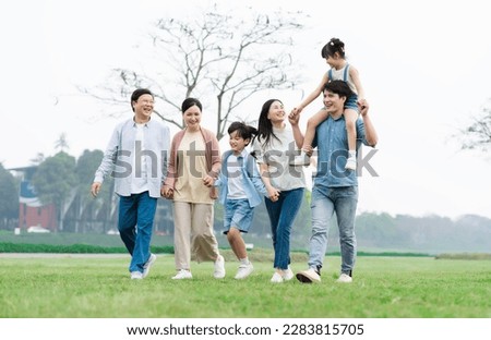 Asian family photo walking together in the park Royalty-Free Stock Photo #2283815705
