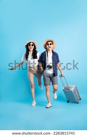 Asian couple traveling image  isolated on blue background