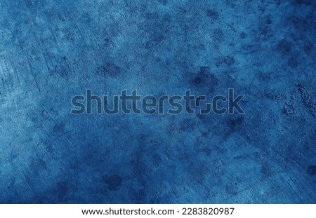 Blue cement wall background with abstract pattern in retro concept for wallpaper or graphic design. Blank plaster texture in vintage style. Dark grunge concrete used for printing.