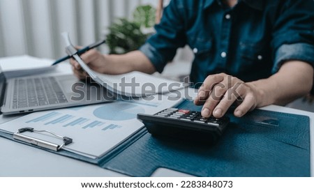 Business bookkeeping with calculator of bookkeeper and household calculating chart graph annual financial account. Royalty-Free Stock Photo #2283848073